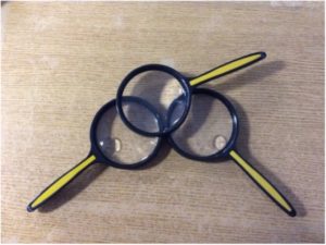 Photo of 3 magnifying glasses on a desk