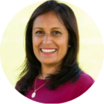 Saima Saleh looking happy. She wears a plain dark pink top and has long, straight brown hair and dark eyes.