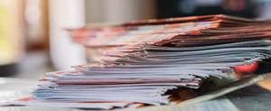 A pile of booklets on a desk