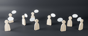 Multiple wooden figures with speech clouds on a dark background.