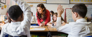 Teacher teaching primary pupils in classroom